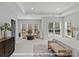 Spacious main bedroom with tray ceiling, neutral decor, and large windows at 276 Gilead Rd, Huntersville, NC 28078