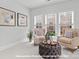 Cozy sitting room with comfortable armchairs, ottoman, and natural light from large windows at 276 Gilead Rd, Huntersville, NC 28078