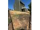 Backyard view shows the home's siding, a back porch, and tiered yard at 2822 Woodlands Creek Dr, Monroe, NC 28110