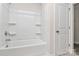 Bright bathroom with a white shower-tub combo and modern fixtures at 2822 Woodlands Creek Dr, Monroe, NC 28110