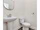 Half bath with pedestal sink and toilet, perfect for guests at 2822 Woodlands Creek Dr, Monroe, NC 28110