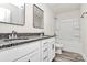 Bathroom with double granite vanity, white cabinets, and a shower-tub combo at 2822 Woodlands Creek Dr, Monroe, NC 28110