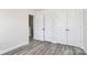 This bedroom features modern flooring and a closet for storage solutions at 2822 Woodlands Creek Dr, Monroe, NC 28110