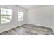 Bedroom featuring two windows, light walls, and modern flooring at 2822 Woodlands Creek Dr, Monroe, NC 28110