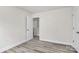 This cozy bedroom offers classic neutral walls and wood-look floors at 2822 Woodlands Creek Dr, Monroe, NC 28110