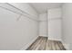 A walk-in closet featuring wire shelving and wood-look flooring at 2822 Woodlands Creek Dr, Monroe, NC 28110