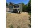 Charming two-story home with a covered porch, manicured lawn and ample yard space at 2822 Woodlands Creek Dr, Monroe, NC 28110