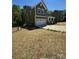 Two-story home with two-car garage, green siding and a manicured lawn at 2822 Woodlands Creek Dr, Monroe, NC 28110