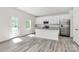 Bright kitchen with stainless steel appliances, gray countertops and an island at 2822 Woodlands Creek Dr, Monroe, NC 28110