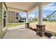 Inviting porch with stone pillars, brick accents, and a view of the neighborhood at 2822 Woodlands Creek Dr, Monroe, NC 28110