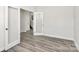 Bright room with modern gray wood floors and doorway with glass door at 2822 Woodlands Creek Dr, Monroe, NC 28110