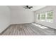 Bright room with three windows and gray wood flooring at 2822 Woodlands Creek Dr, Monroe, NC 28110