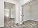 Bright room with modern gray wood floors and doorway with glass door at 2822 Woodlands Creek Dr, Monroe, NC 28110