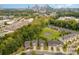 Wide aerial view capturing homes near a pond, lush greenery and the city skyline at 3614 Dolly Madison Rd, Charlotte, NC 28208