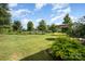 Spacious backyard with a lush green lawn, shade trees, and room for outdoor activities at 3614 Dolly Madison Rd, Charlotte, NC 28208