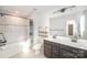 Bright bathroom features a vanity with dual sinks, dark cabinets, and a shower-tub combo with tiled walls at 3614 Dolly Madison Rd, Charlotte, NC 28208