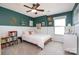 Stylish bedroom with green accent wall, white trim, ceiling fan, and a cozy, inviting atmosphere at 3614 Dolly Madison Rd, Charlotte, NC 28208
