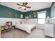 Stylish bedroom with white walls, green accent wall, and fan boasts a bright and cozy atmosphere at 3614 Dolly Madison Rd, Charlotte, NC 28208