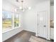 Bright breakfast nook features large windows, shiplap accent wall, dark wood flooring, and modern lighting at 3614 Dolly Madison Rd, Charlotte, NC 28208