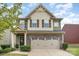 Charming two-story home featuring a stone facade, attached two-car garage, and a welcoming front entrance with a wreath at 3614 Dolly Madison Rd, Charlotte, NC 28208