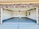 Spacious two-car garage featuring a stone accent wall and epoxy flooring at 3614 Dolly Madison Rd, Charlotte, NC 28208