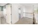Bright second-floor landing featuring neutral carpet and white doors and trim at 3614 Dolly Madison Rd, Charlotte, NC 28208