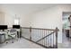 Second-floor landing with a small office area and decorative metal railing at 3614 Dolly Madison Rd, Charlotte, NC 28208