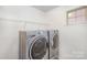Convenient laundry room with front load washer and dryer and wire shelving at 3614 Dolly Madison Rd, Charlotte, NC 28208