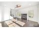 Open-concept living room with a gas fireplace, large windows, and dark wood flooring at 3614 Dolly Madison Rd, Charlotte, NC 28208