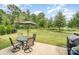 Outdoor patio featuring a table with chairs and a grill, perfect for dining and relaxation at 3614 Dolly Madison Rd, Charlotte, NC 28208