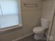 Functional bathroom featuring a toilet, sleek floors, and natural light creating a comfortable and convenient space at 3703 Crawford St, Gastonia, NC 28052