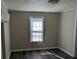Bright bedroom with neutral walls, large window, and sleek floors offering a comfortable and inviting space at 3703 Crawford St, Gastonia, NC 28052