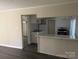 Inviting view of the kitchen with granite countertops, white cabinets, and stainless steel appliances from the living area at 3703 Crawford St, Gastonia, NC 28052