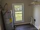Utility room featuring an efficient water heater, sleek floors, and ample natural light creating a functional area at 3703 Crawford St, Gastonia, NC 28052