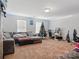 Spacious bonus room with plenty of space for a sectional sofa, desk, and Christmas tree at 3812 Caldwell Ridge Pkwy, Charlotte, NC 28213