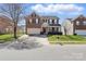 Charming two-story home with a brick and beige facade, two-car garage, manicured lawn and a red front door at 3812 Caldwell Ridge Pkwy, Charlotte, NC 28213