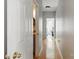 Hallway with hardwood floors that leads to a bathroom with granite counters and neutral decor at 3812 Caldwell Ridge Pkwy, Charlotte, NC 28213