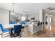 Elegant kitchen with light blue cabinets, granite countertops, stainless steel appliances, and breakfast bar seating at 3812 Caldwell Ridge Pkwy, Charlotte, NC 28213