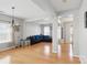 Bright, open-concept living room with hardwood floors, modern chandelier, and a comfortable blue sectional sofa at 3812 Caldwell Ridge Pkwy, Charlotte, NC 28213