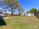 Spacious backyard featuring a well-kept lawn and a detached storage shed at 3816 Sonoma Way, Monroe, NC 28110