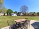 Spacious backyard with a patio table, fenced yard, and storage shed at 3816 Sonoma Way, Monroe, NC 28110