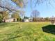 Large backyard with green grass, a shed, and a wooden fence at 3816 Sonoma Way, Monroe, NC 28110