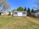 Backyard features a light gray storage shed with double doors and window shutters at 3816 Sonoma Way, Monroe, NC 28110