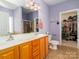 Bathroom featuring double sink vanity, mosaic tile flooring, and walk-in closet at 3816 Sonoma Way, Monroe, NC 28110