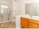 Bathroom with a glass shower and a single sink with oak cabinets at 3816 Sonoma Way, Monroe, NC 28110