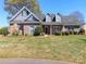 Charming single-story brick home featuring a well-manicured lawn, dormers and a welcoming entrance at 3816 Sonoma Way, Monroe, NC 28110