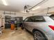 Well-lit garage space with tool storage and a gray vehicle at 3816 Sonoma Way, Monroe, NC 28110
