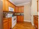 A well-appointed kitchen featuring wood cabinets and white appliances at 3816 Sonoma Way, Monroe, NC 28110