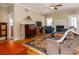 Cozy living room with fireplace, hardwood floors, and comfortable seating creating an inviting atmosphere at 3816 Sonoma Way, Monroe, NC 28110
