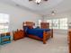 A lovely main bedroom with a wooden bed frame and carpeted floor at 3816 Sonoma Way, Monroe, NC 28110